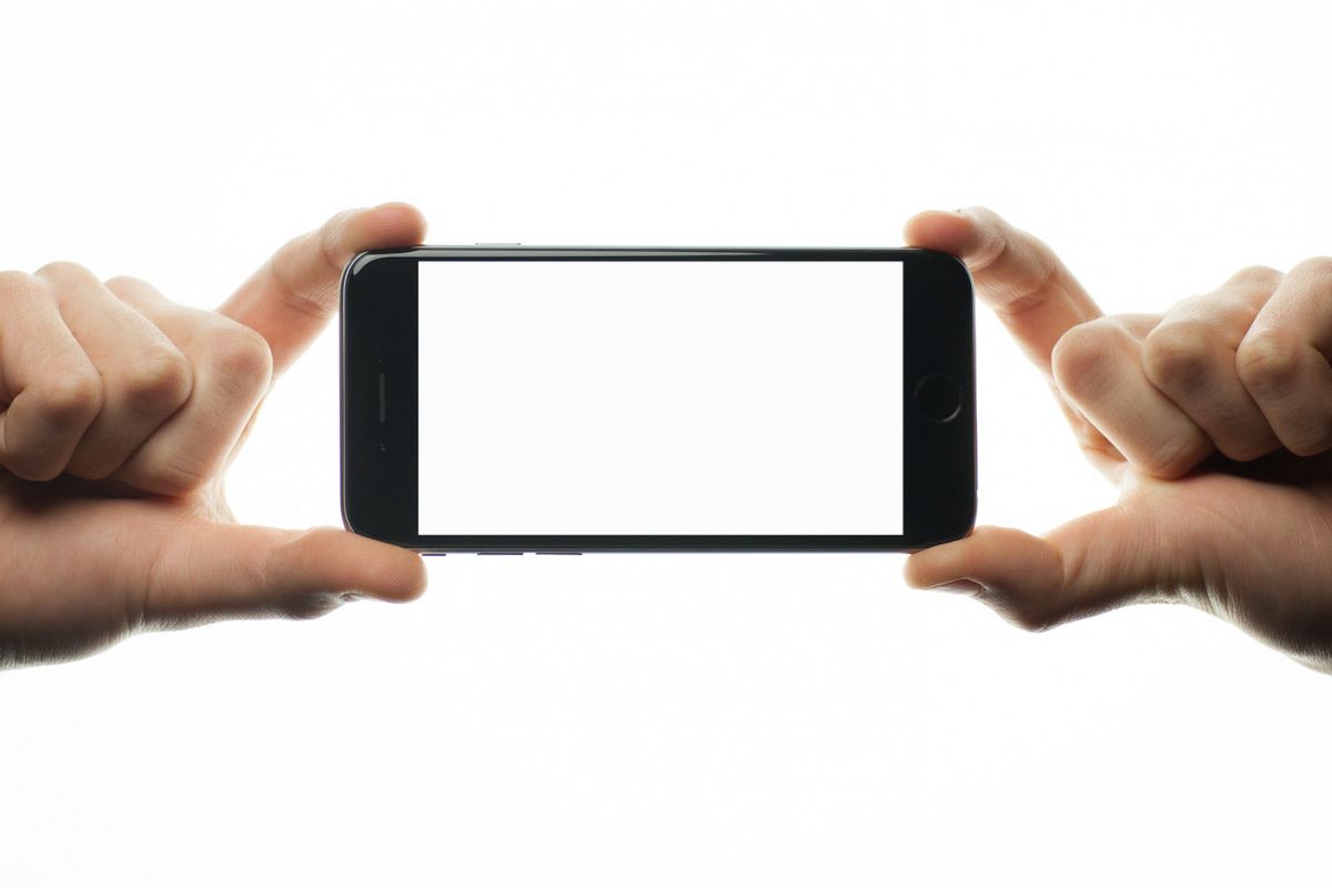 Two hands holding smartphone with blank screen example image 1