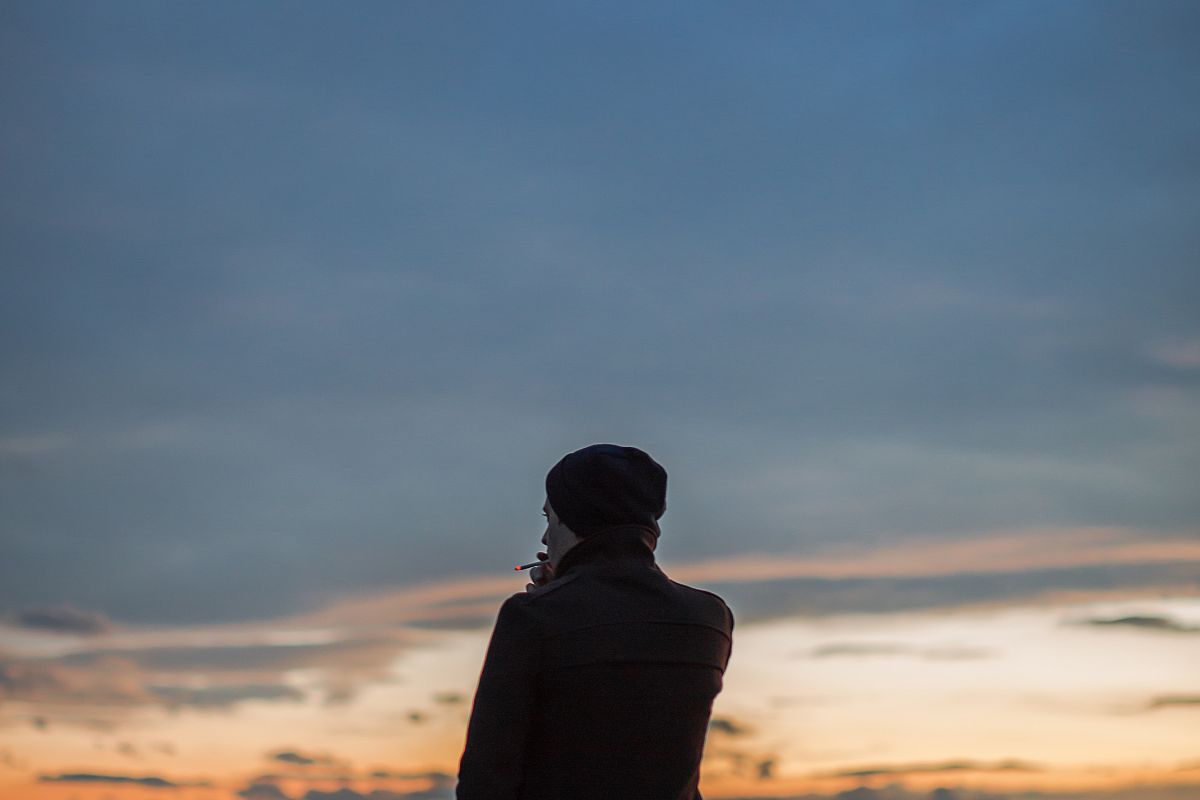 Man watching sunset from the hill example image 1