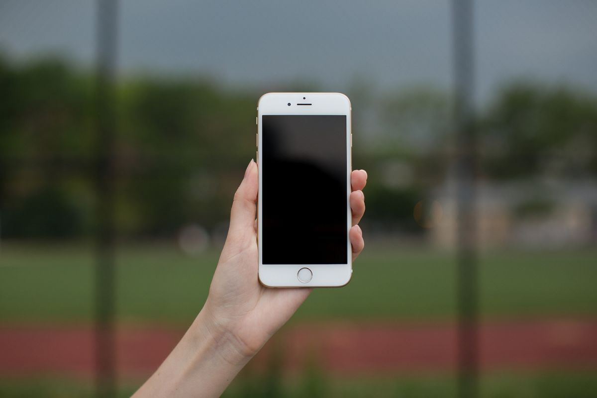 Female hand holding smartphone example image 1