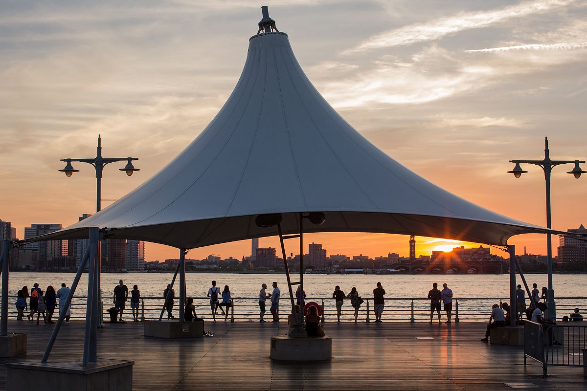 Nice moment group of people enjoying sunset at the pier example image 1