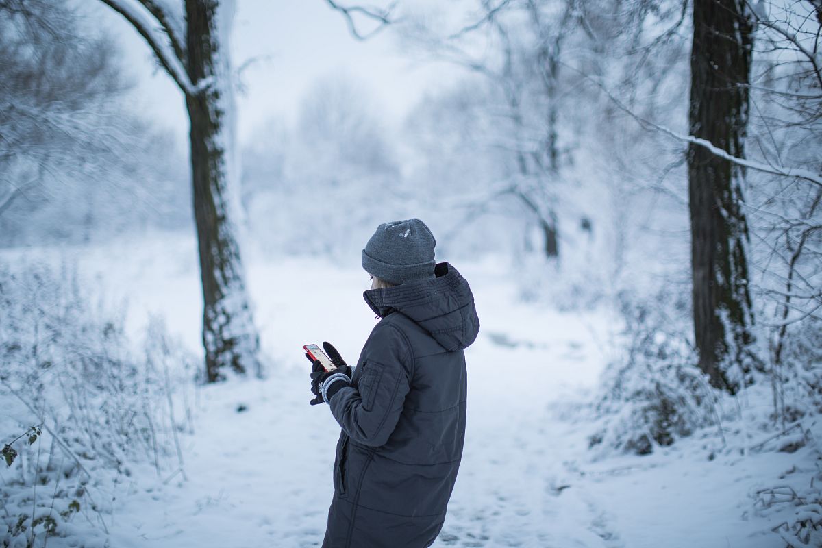 Girl taking photos in the snow forest example image 1