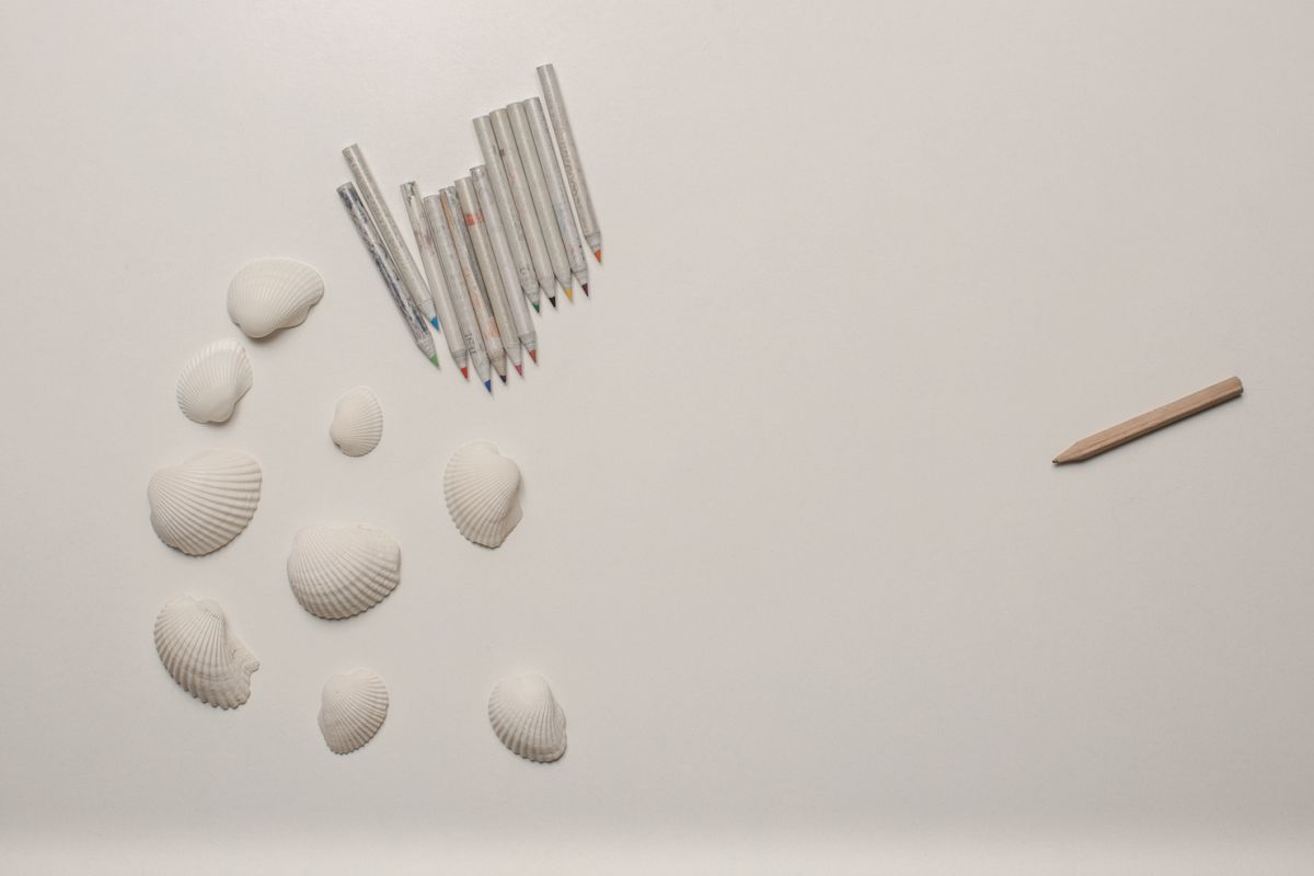 White table with shells and colored pencils example image 1