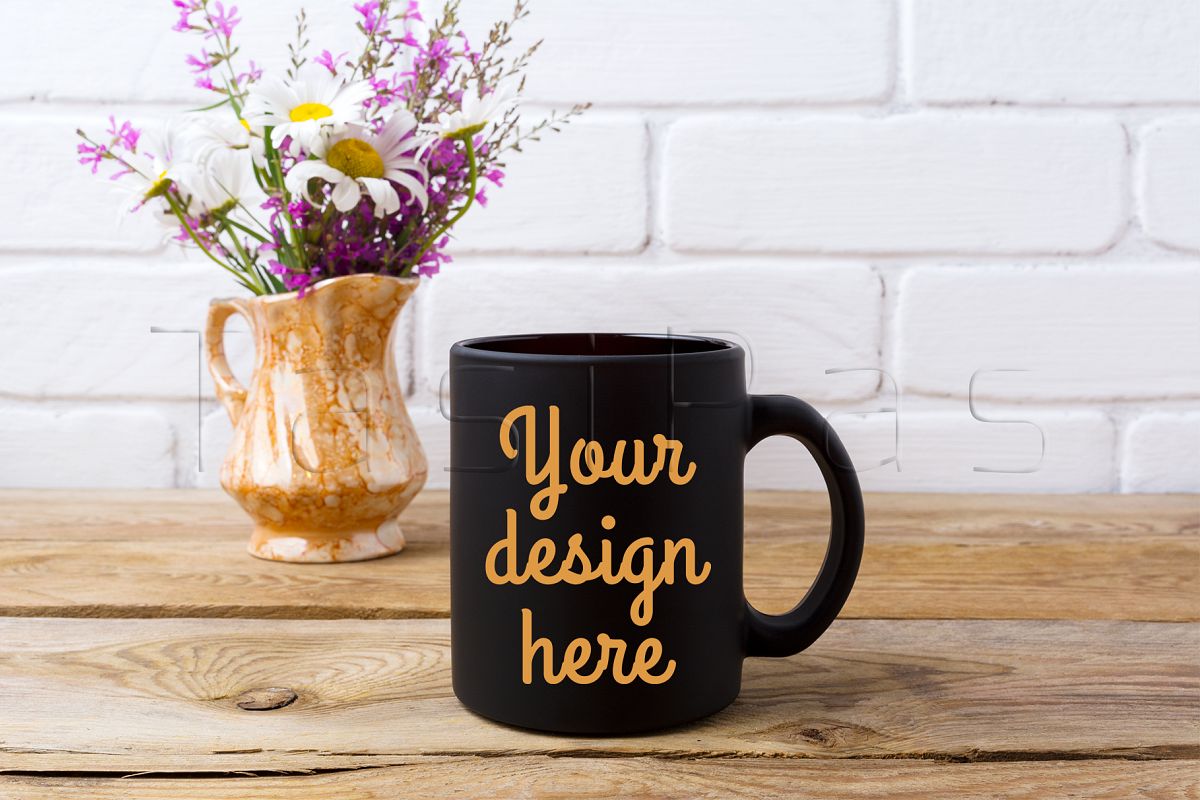 Download Black coffee mug mockup with white chamomile and purple field flowers in golden pitcher vase ...