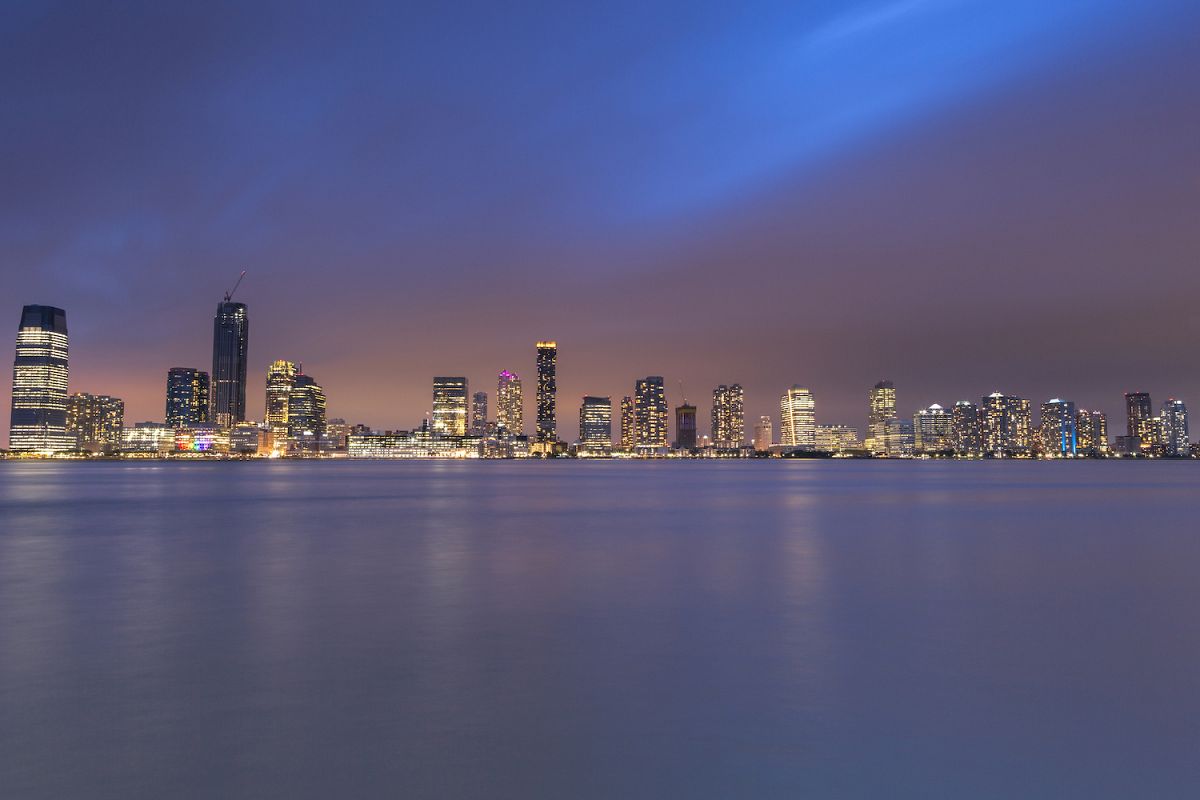 Jersey City skyscraper view at night from Hudson river a example image 1