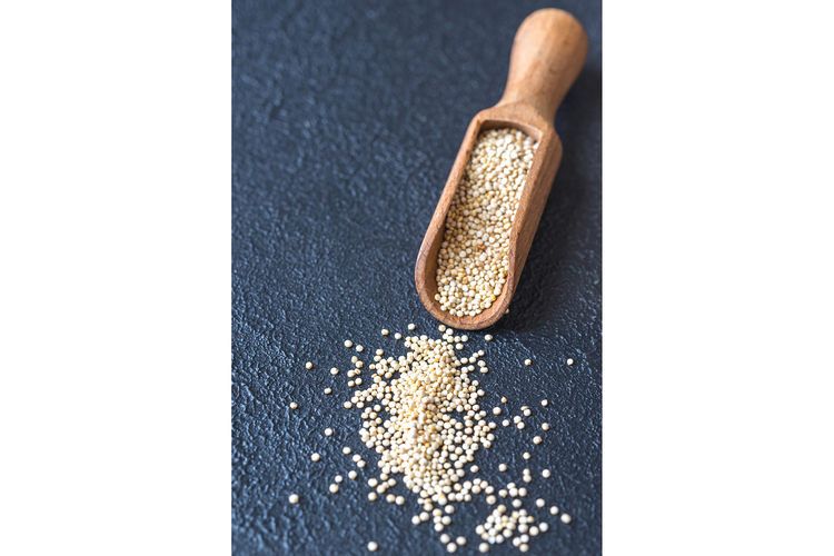 Scoop of raw quinoa example image 1