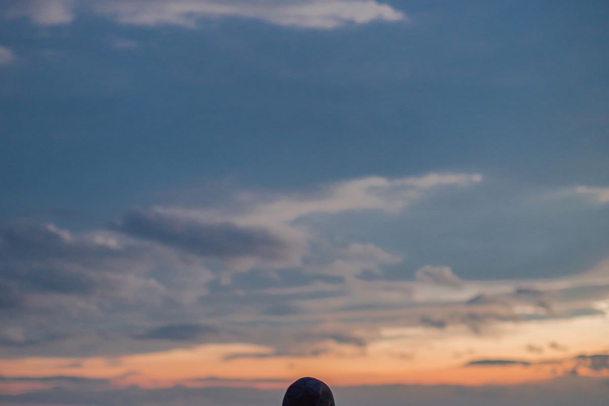 Man watching sunset from the hill example image 1