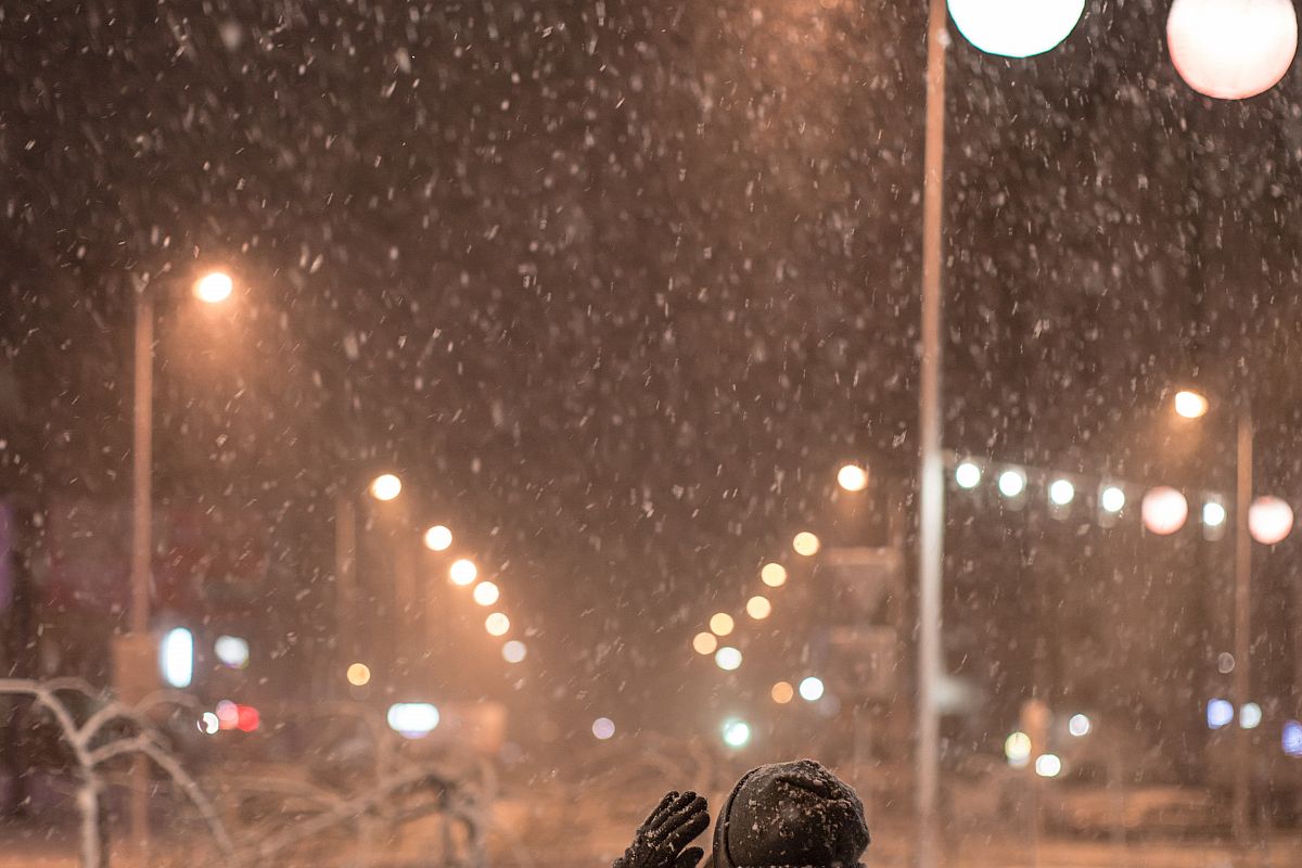 Girl enjoying snowfall night example image 1
