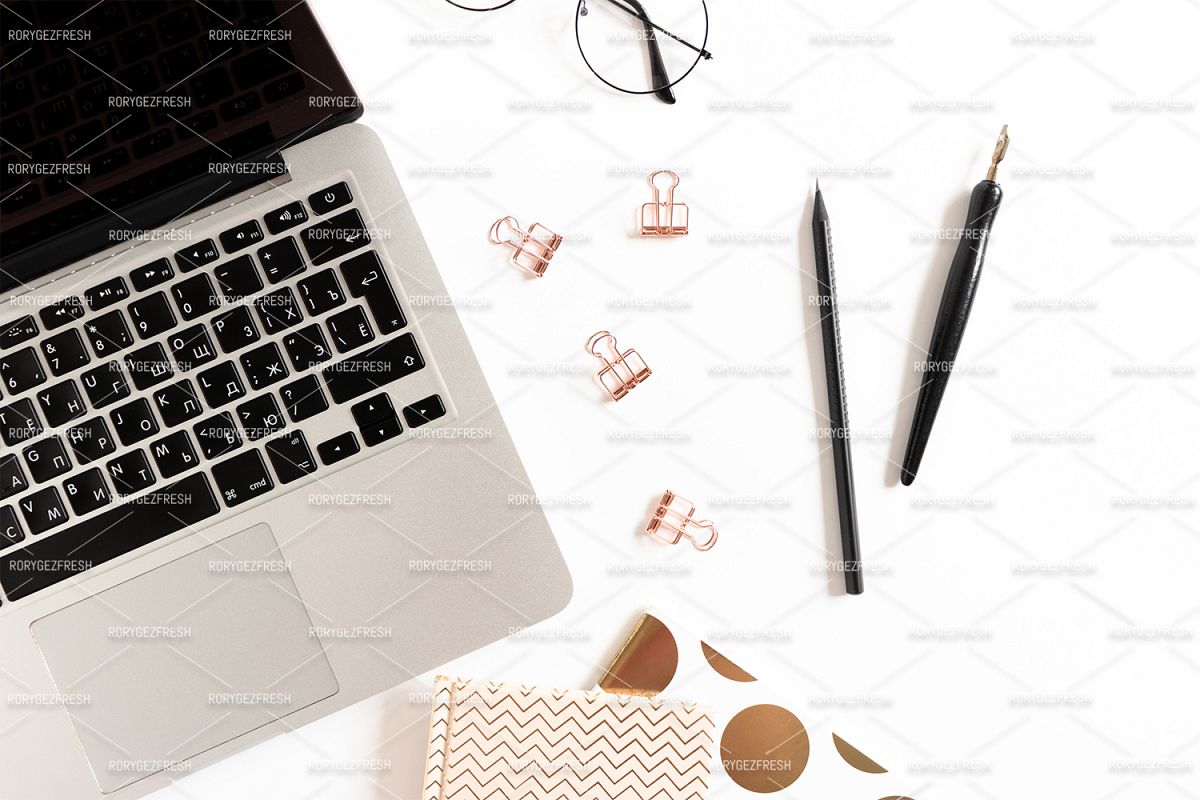 Office desk with laptop, golden notepads, glasses example image 1