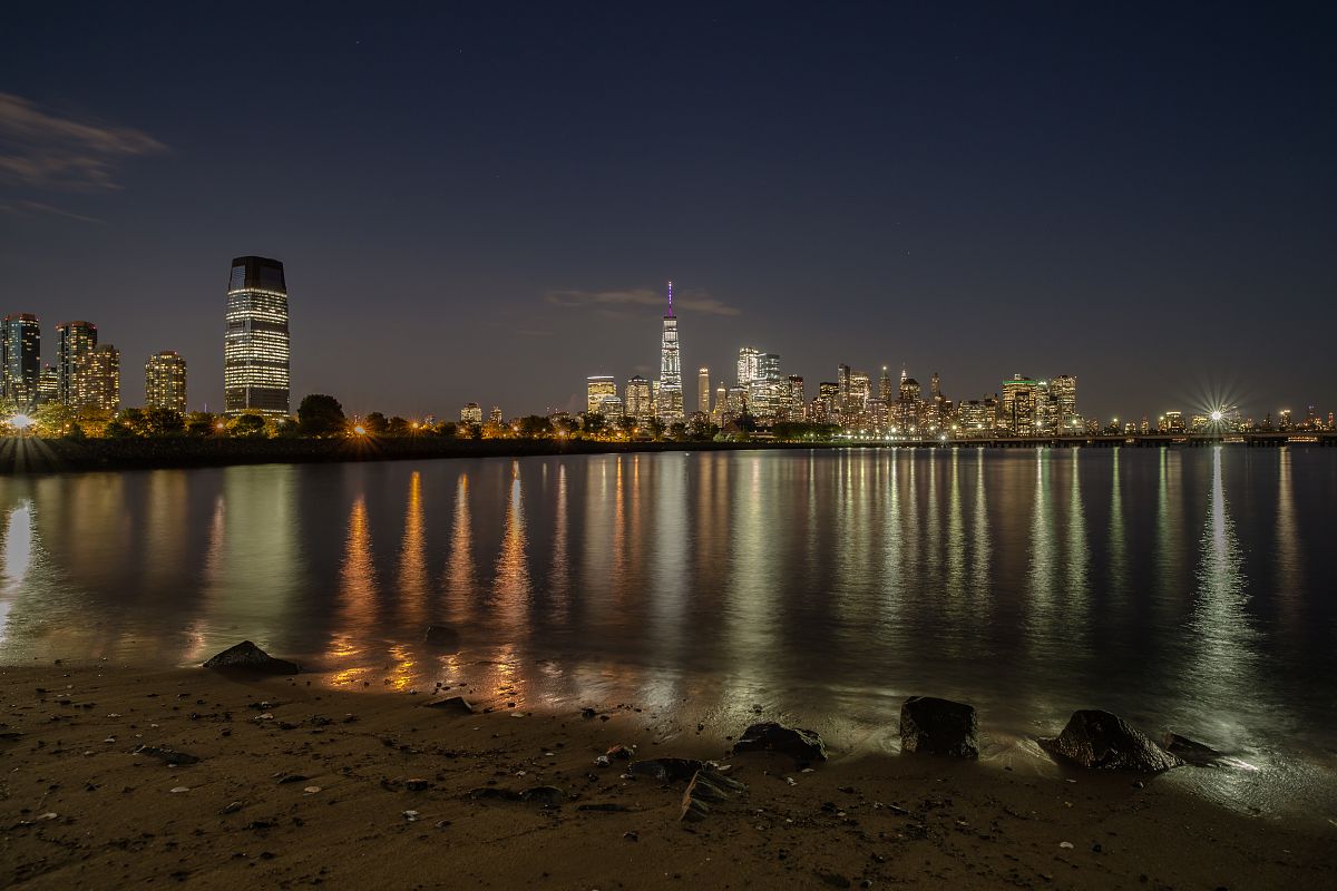 Manhattan and jersey city view during twilight from the sand beach example image 1