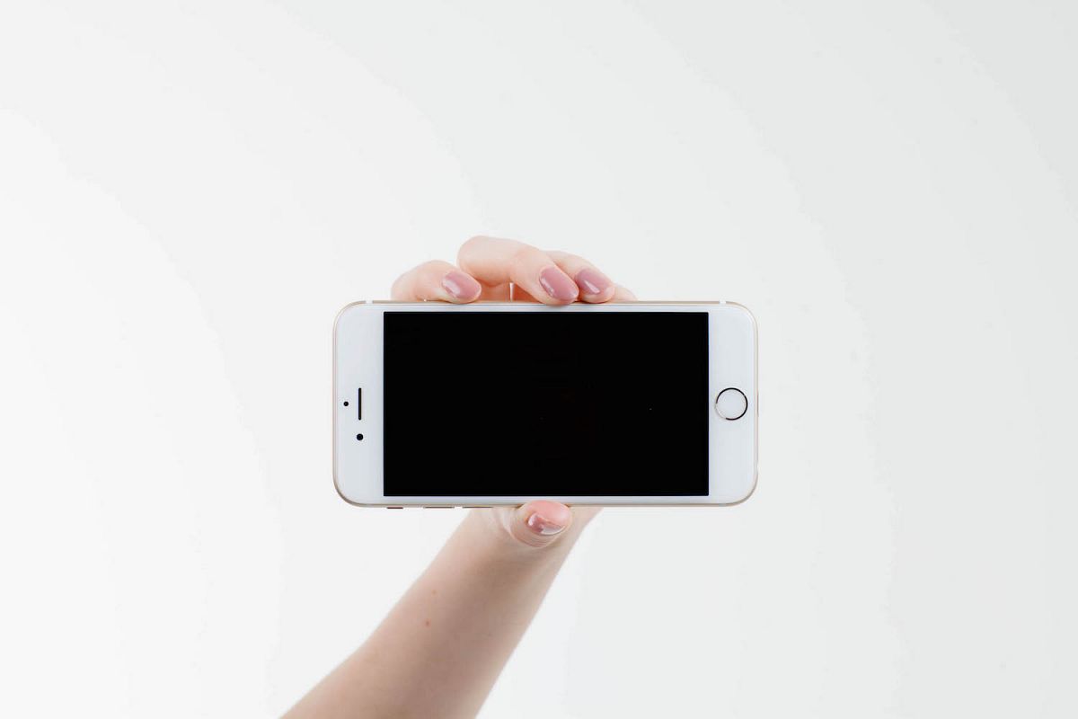 Woman holding mobile smart phone with blank screen example image 1